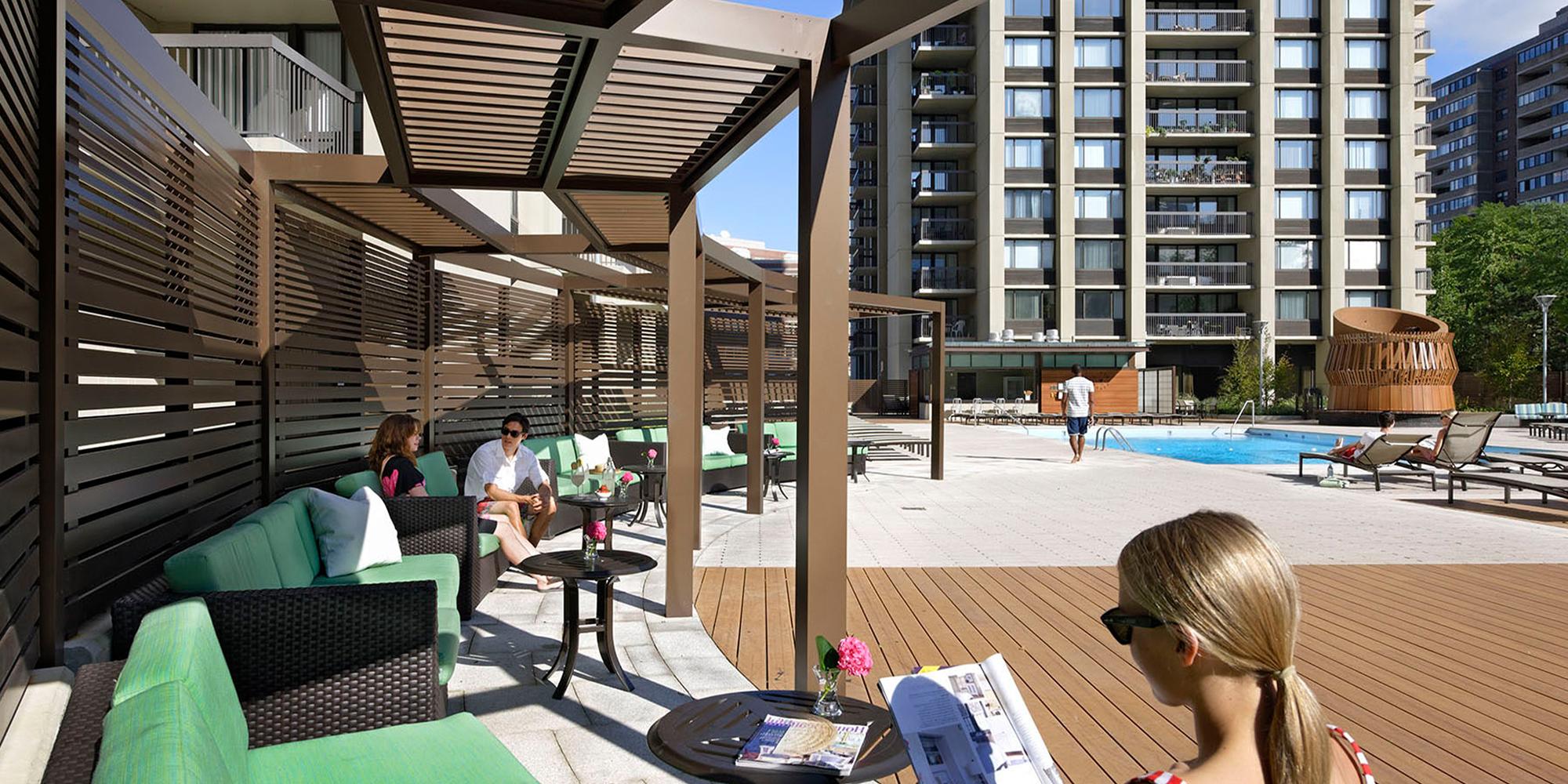 Residents enjoying the mezzanine terrace and pool at West End Longfellow Apartment Complex Boston